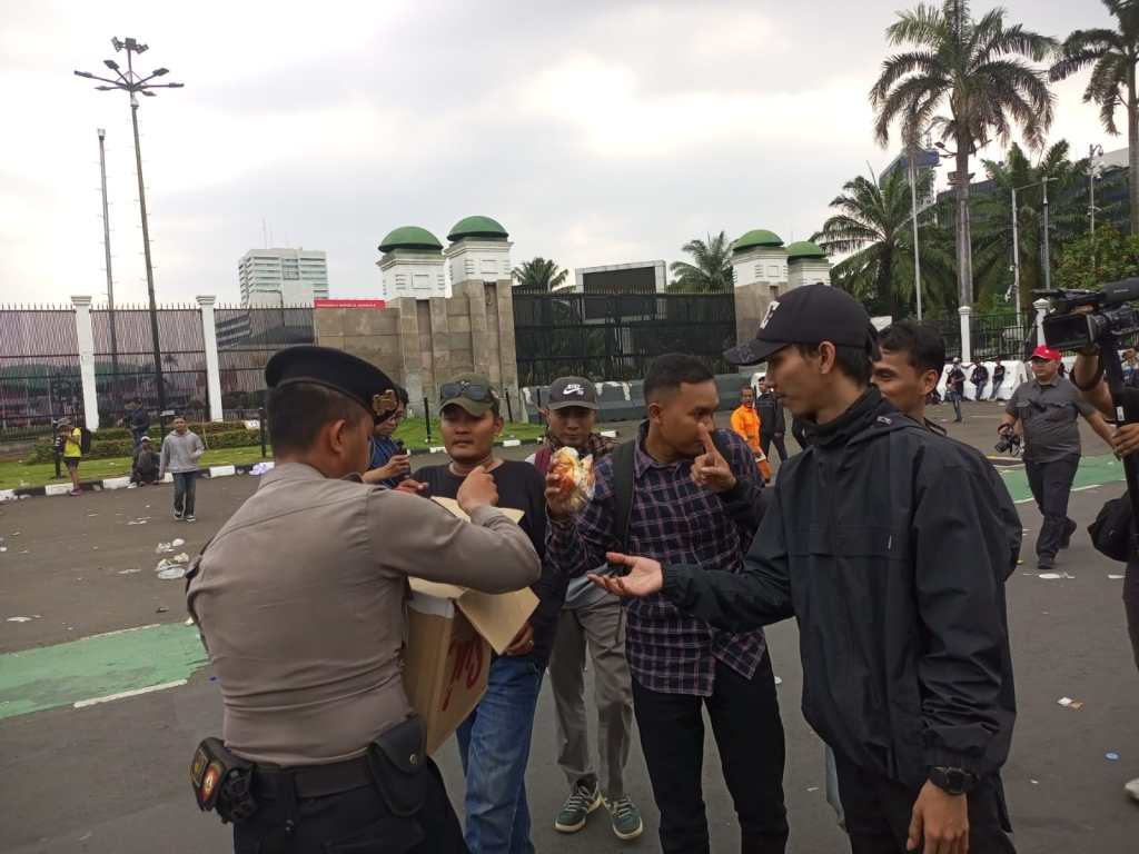 Aksi Simpatik, Polisi Bagikan Air Mineral dan Roti kepada Buruh di Depan&nbsp;DPR/MPR